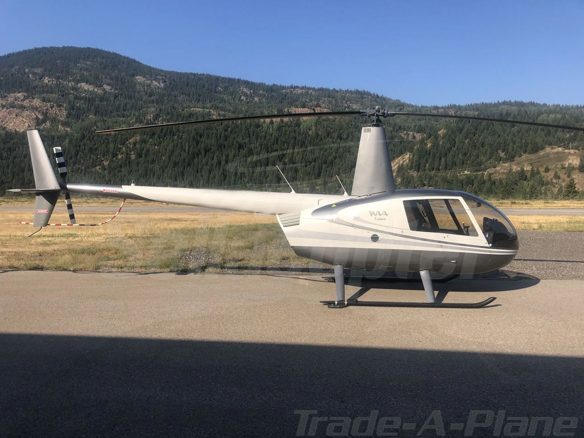 Exterior view of a 2017 ROBINSON R44, C-GFEE.