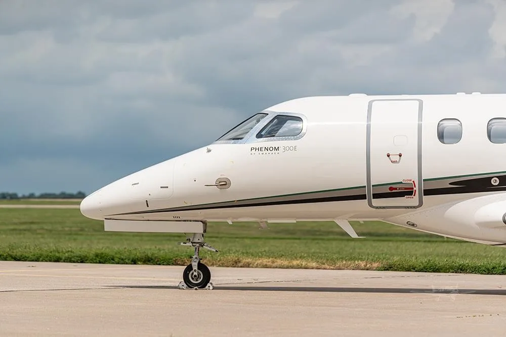 Exterior view of a 2018 EMBRAER PHENOM 300E, N156PG.