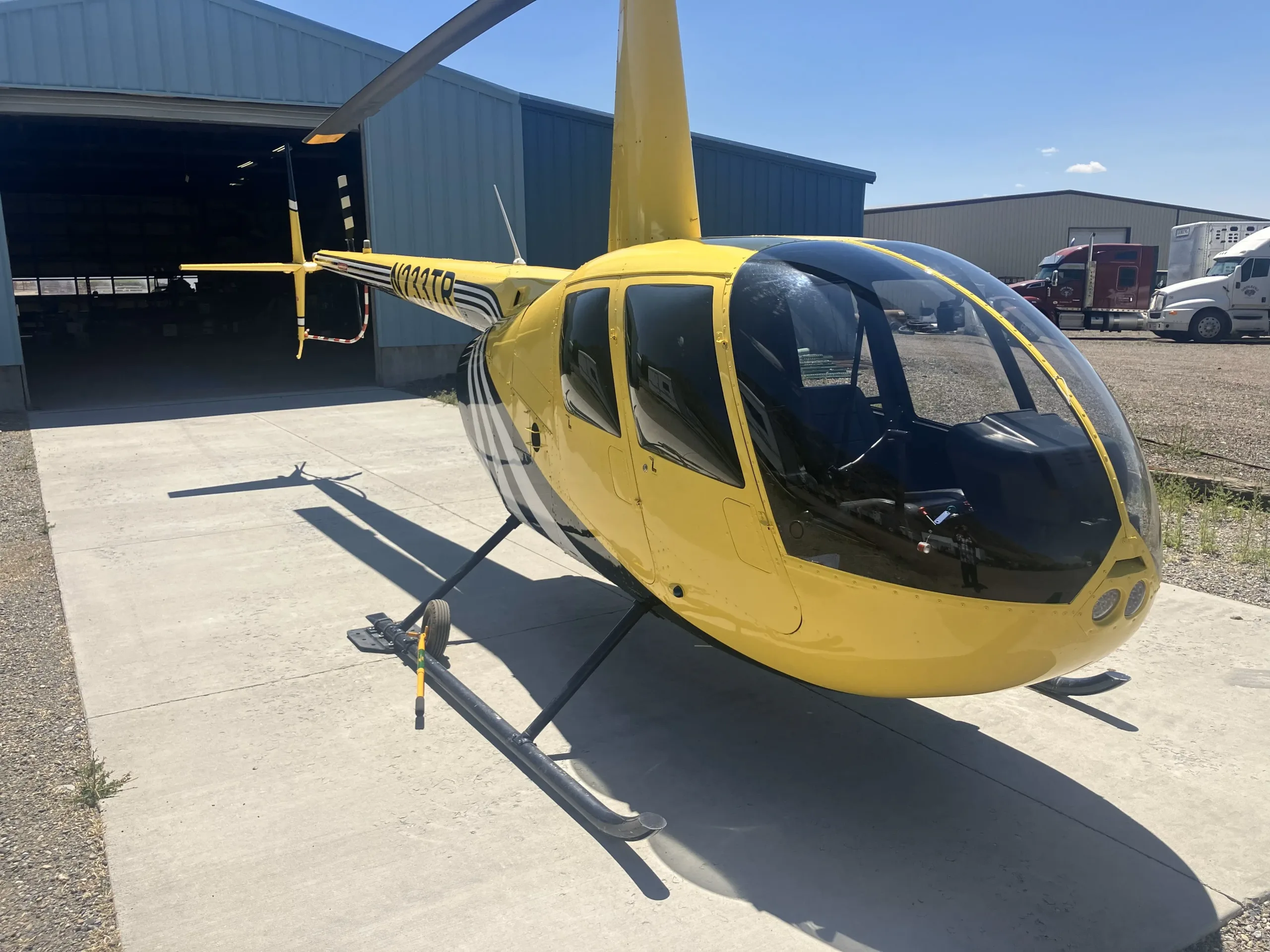 Exterior view of a 2003 Robinson R44 II, N233TR.