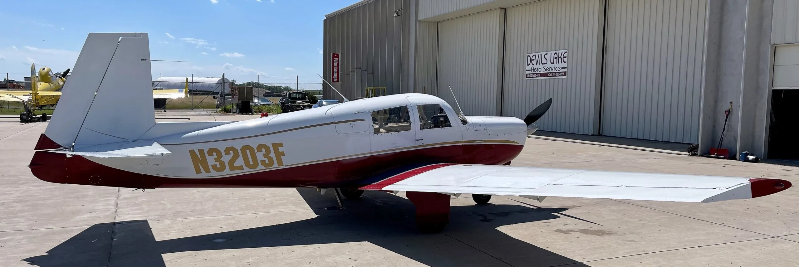 Exterior view of a 1967 Mooney M20C, N3203F.
