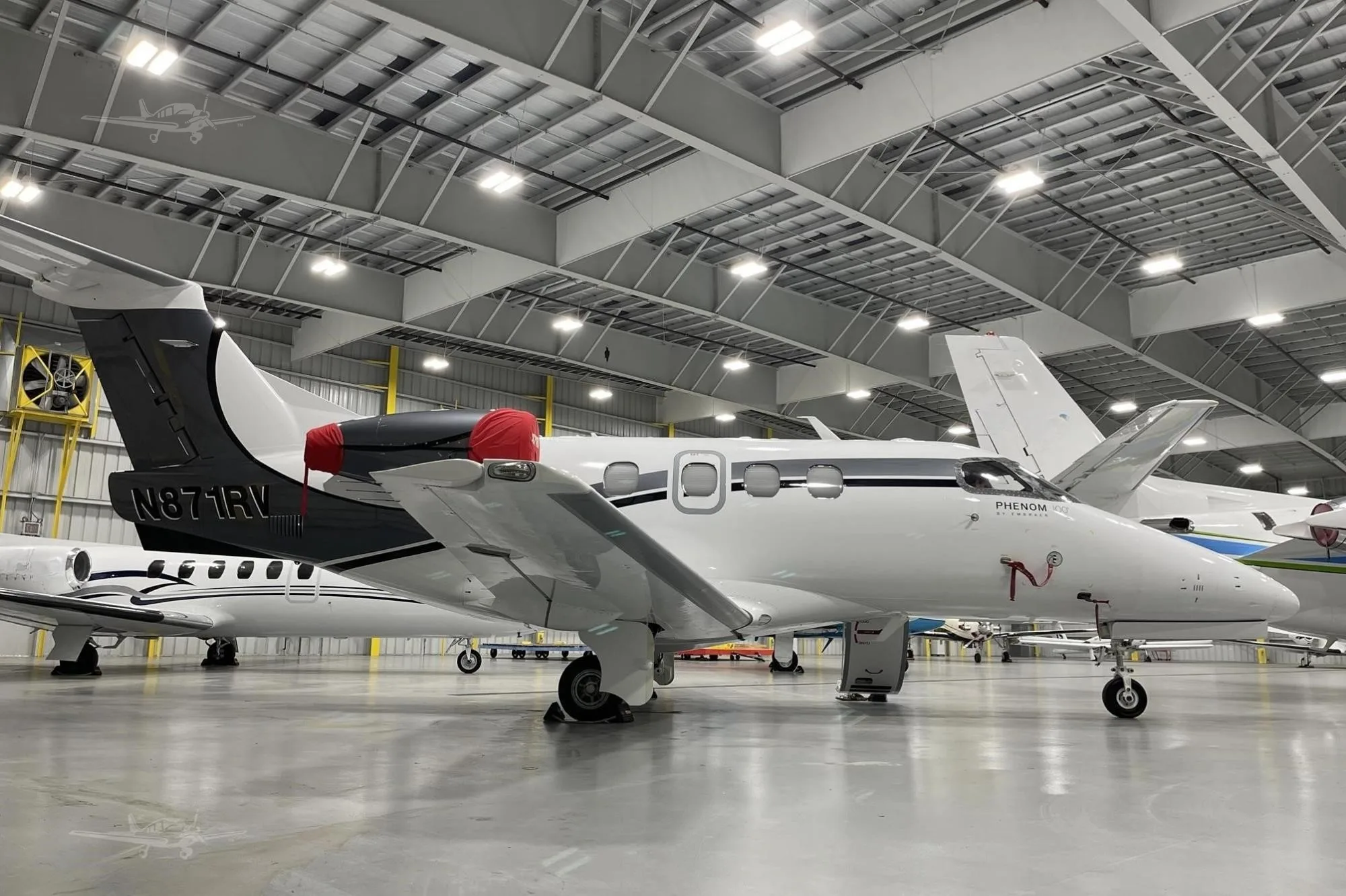 Exterior view of a 2012 EMBRAER PHENOM 100, N871RV.
