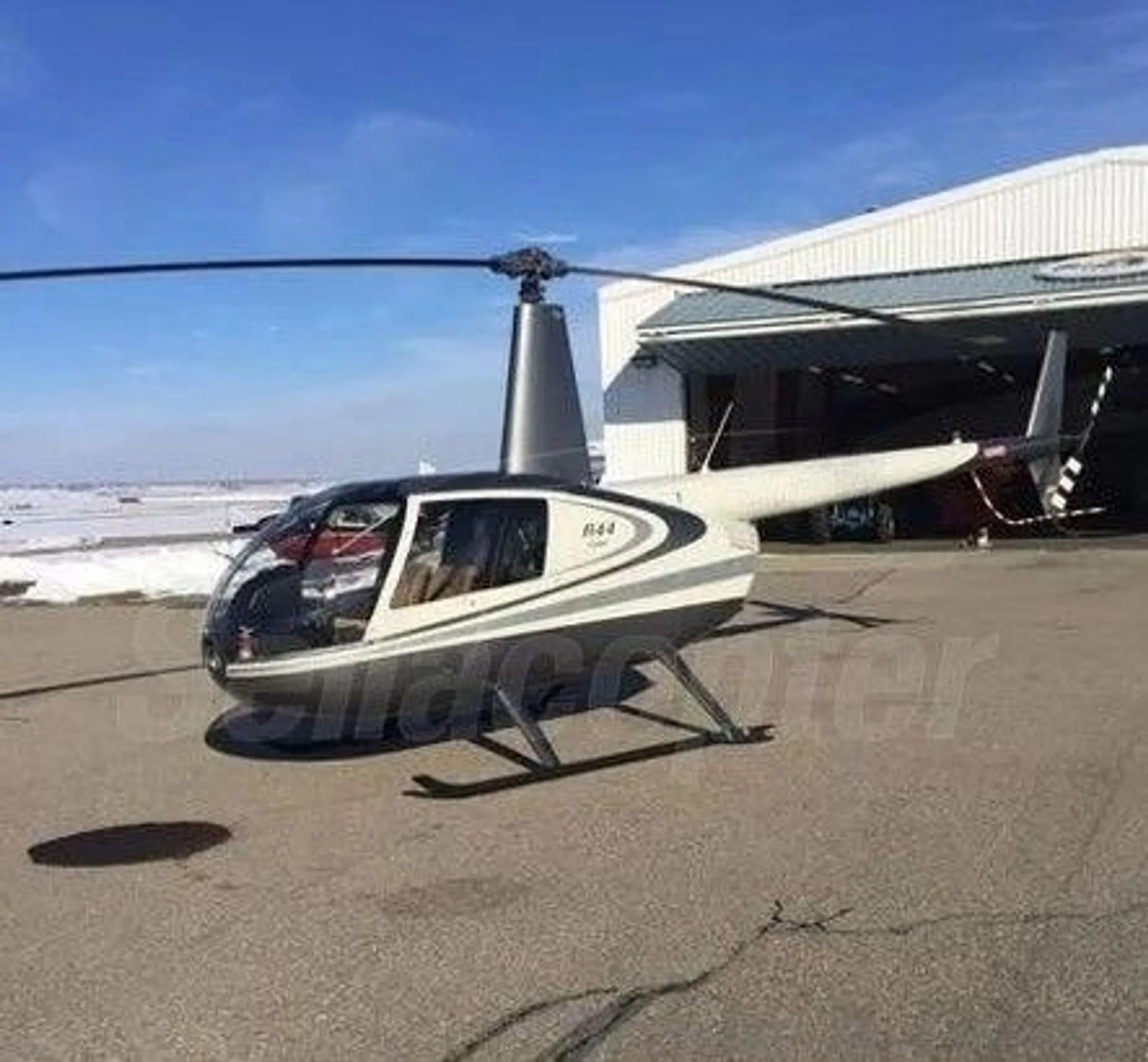 Exterior view of a 2017 ROBINSON R44, C-GFEE.
