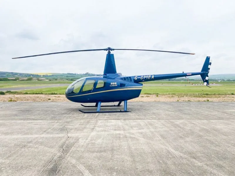 Exterior view of a 2011 Robinson R66, G-CMEA.