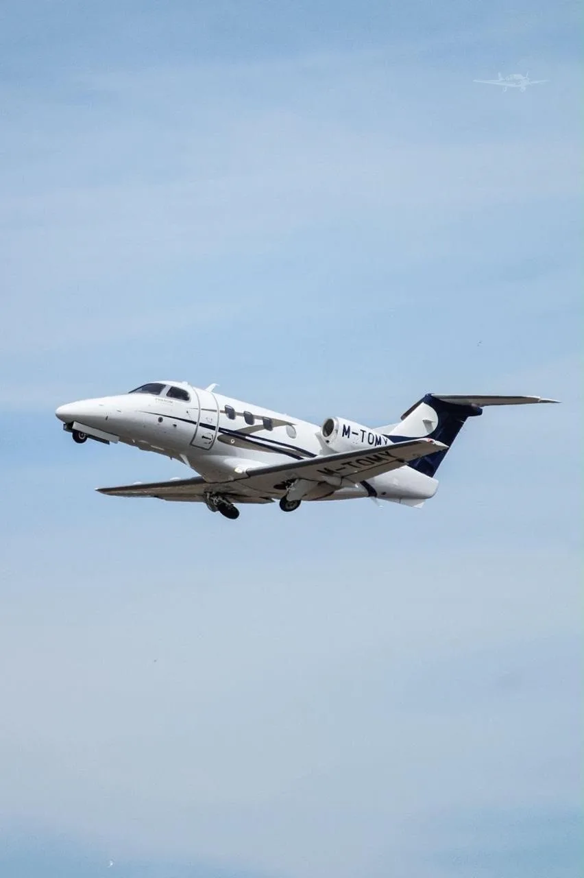 Exterior view of a 2016 EMBRAER PHENOM 100E, M-TOMY.