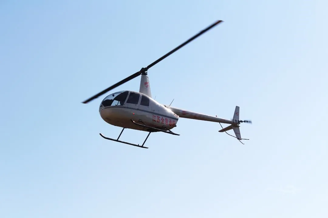 Exterior view of a 2015 ROBINSON R44 RAVEN II.