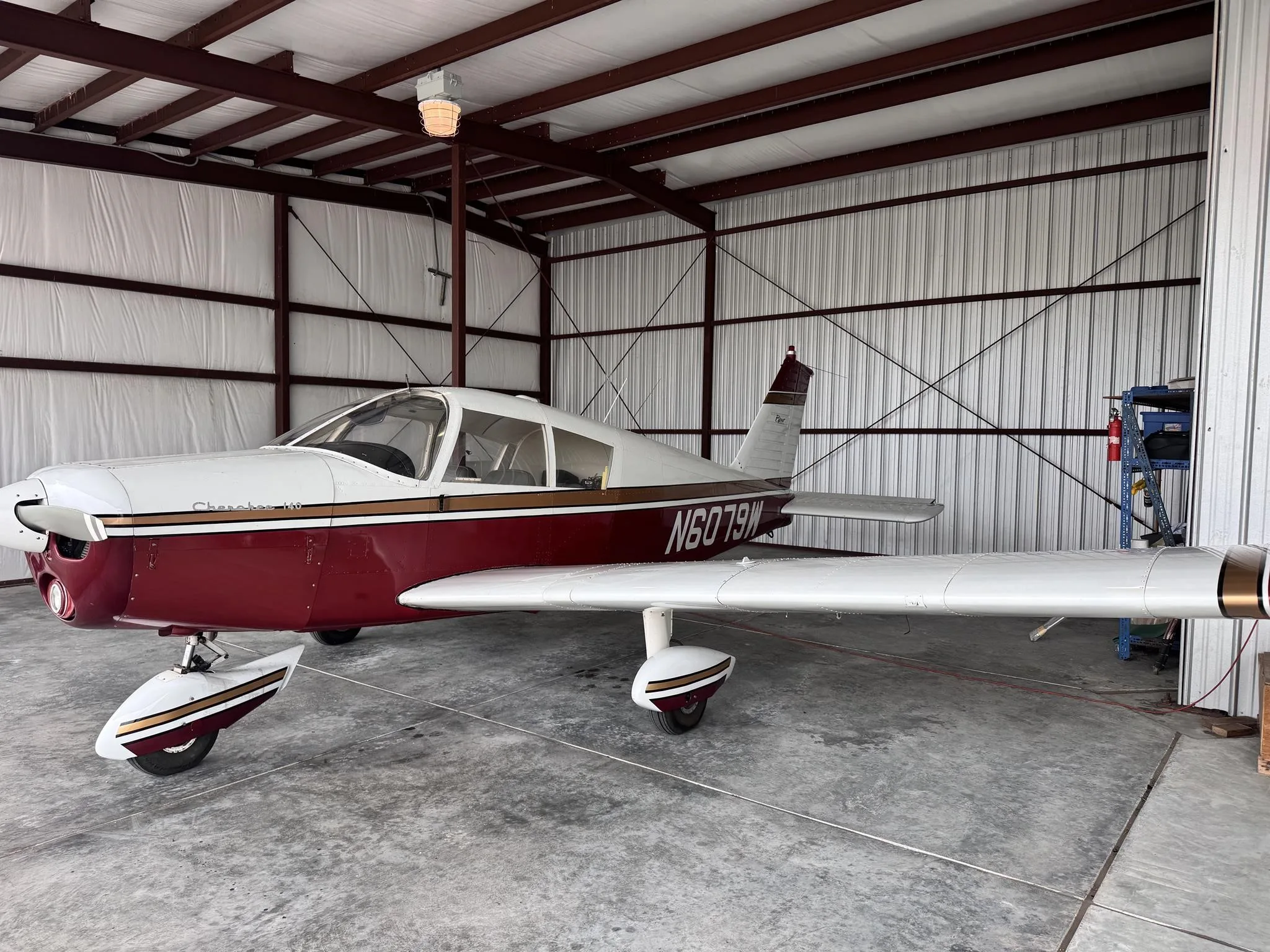 Exterior view of a 1964 PIPER CHEROKEE 140, N6079W.