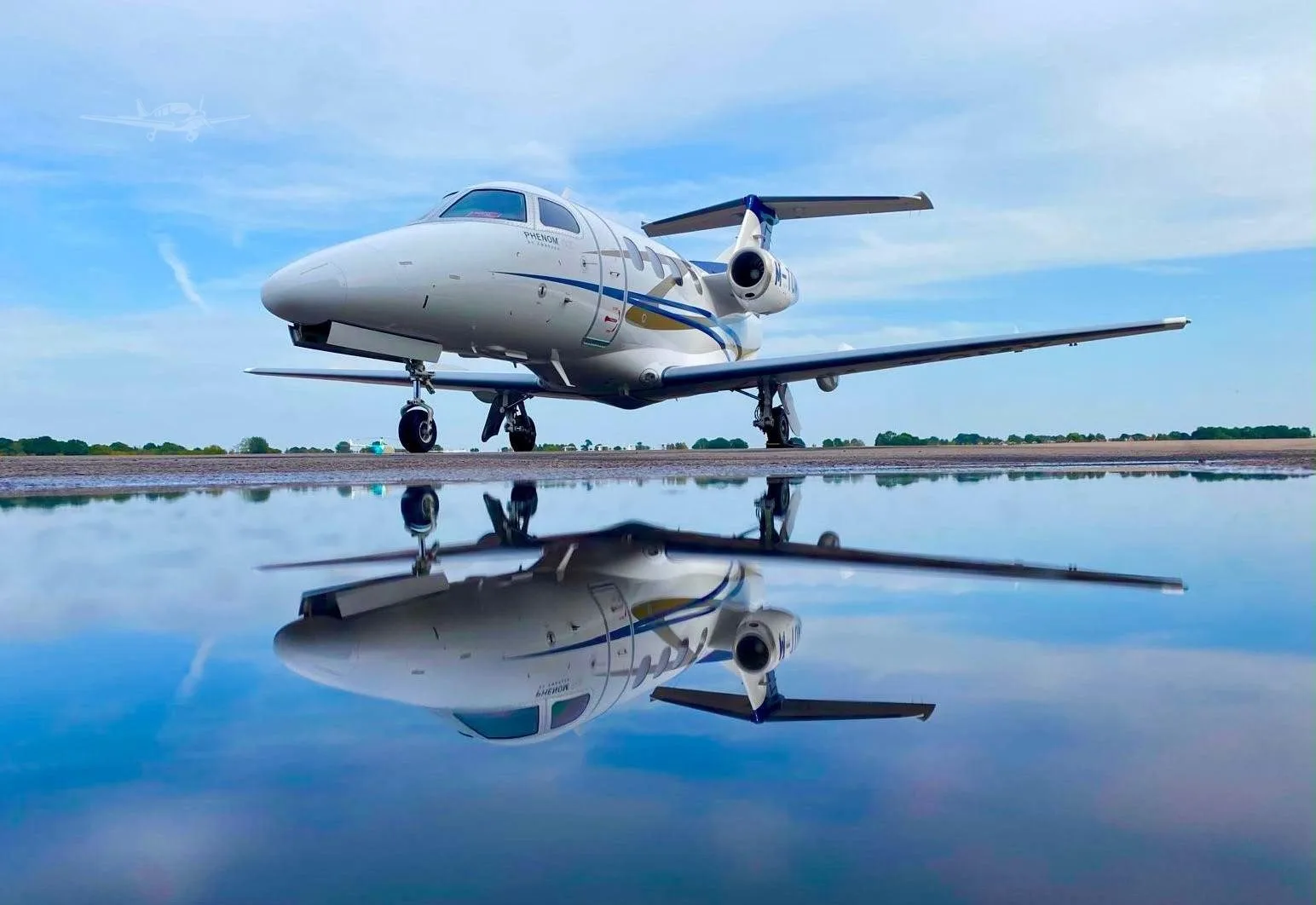 Exterior view of a 2016 EMBRAER PHENOM 100E, M-TOMY.