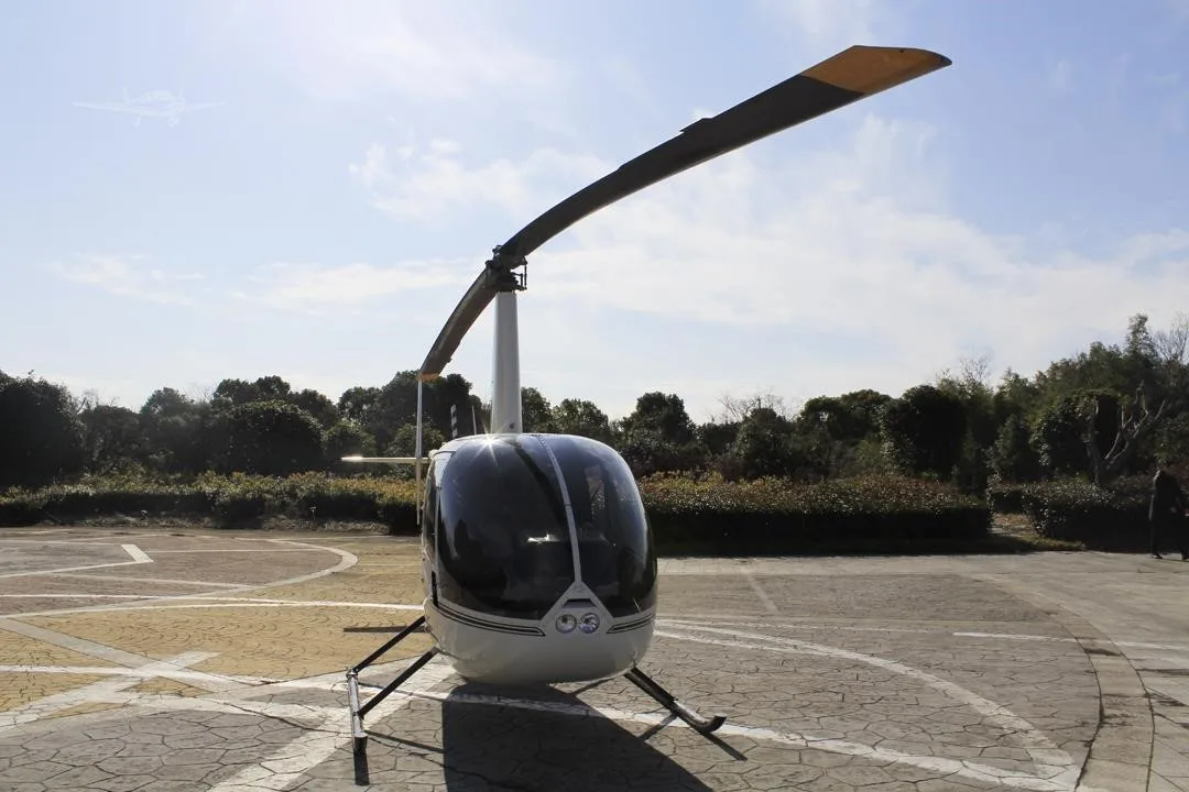 Exterior view of a 2014 ROBINSON R44 RAVEN II.