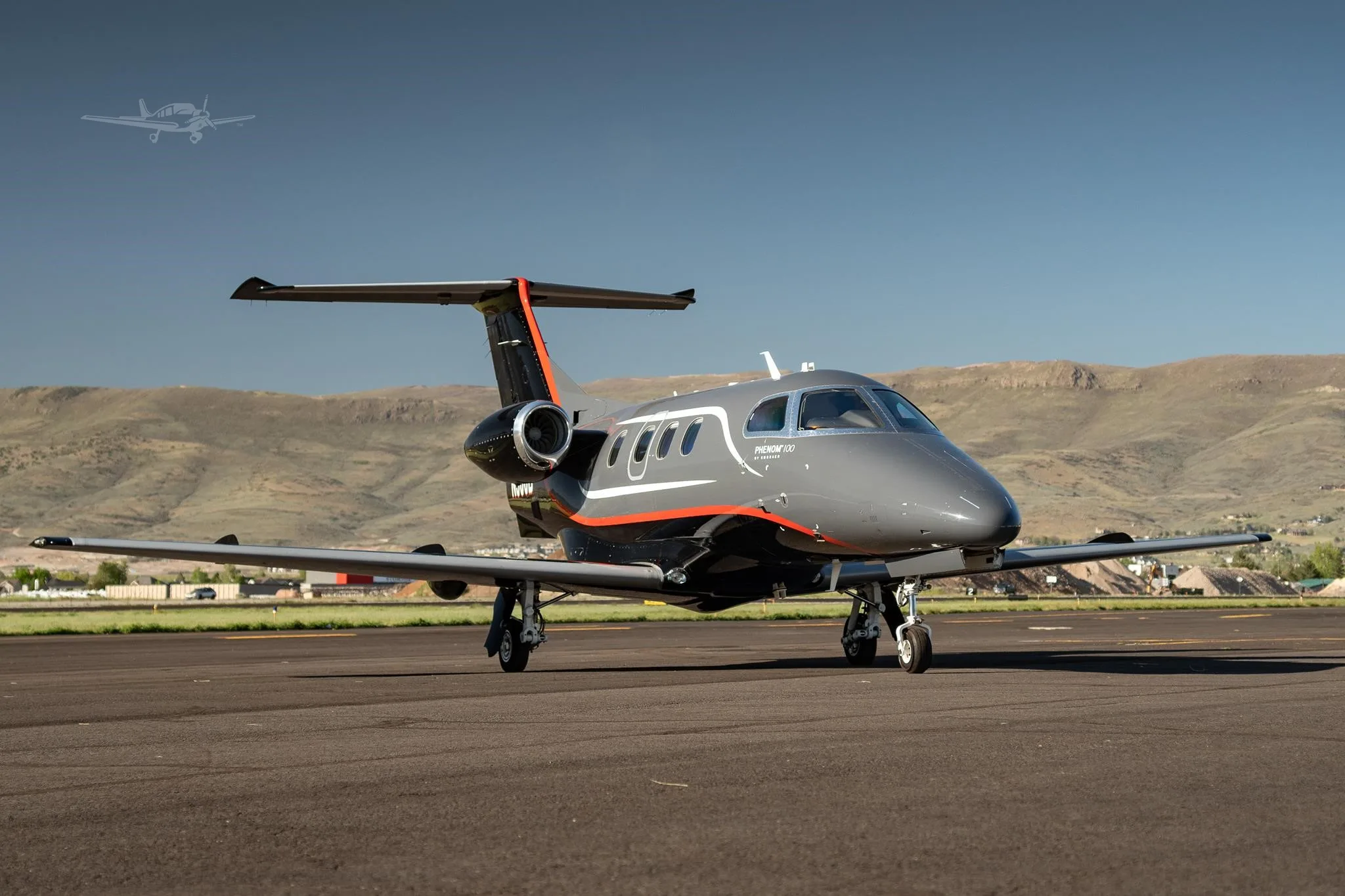 Exterior view of a 2013 EMBRAER PHENOM 100, N506B.