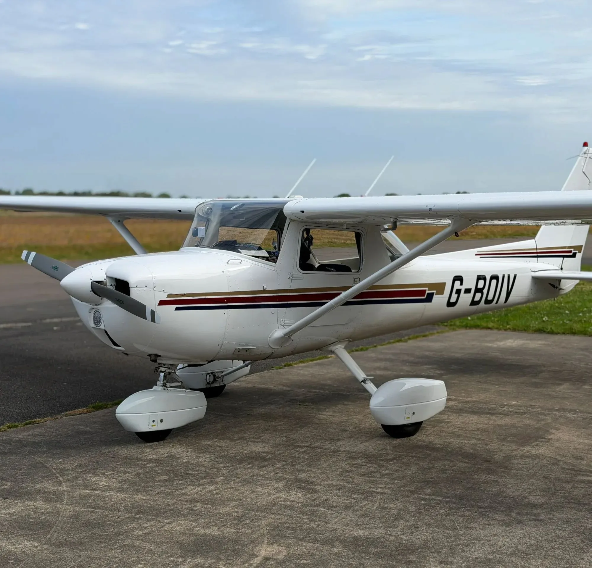 Exterior view of a 1976 Cessna 150M, G-BOIV.