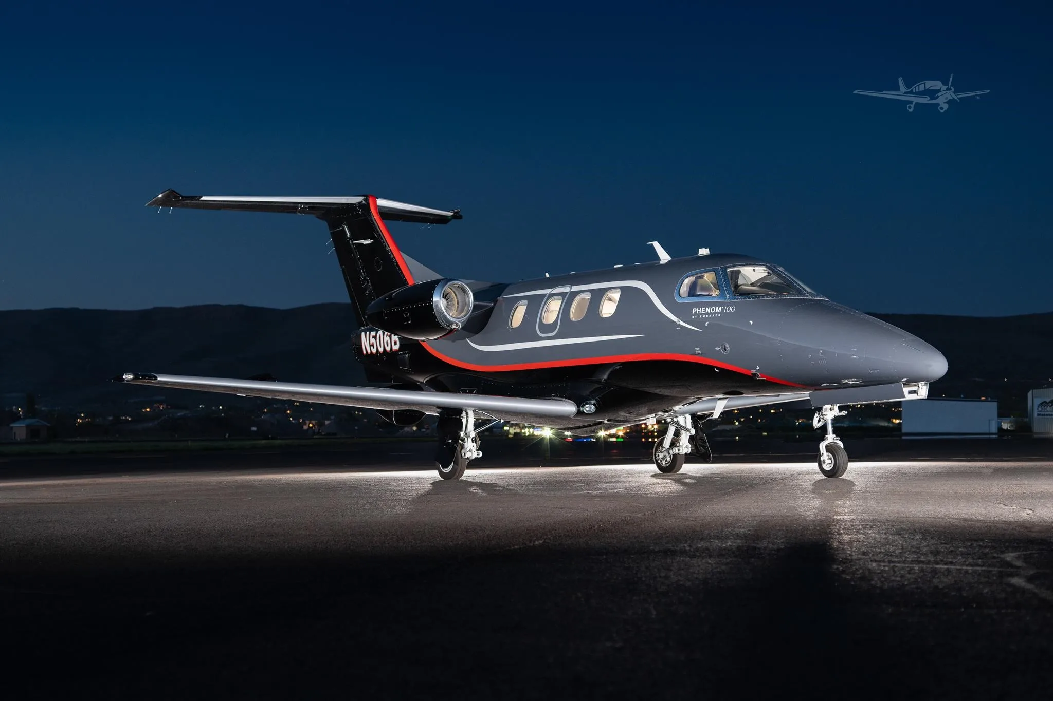 Exterior view of a 2013 EMBRAER PHENOM 100, N506B.