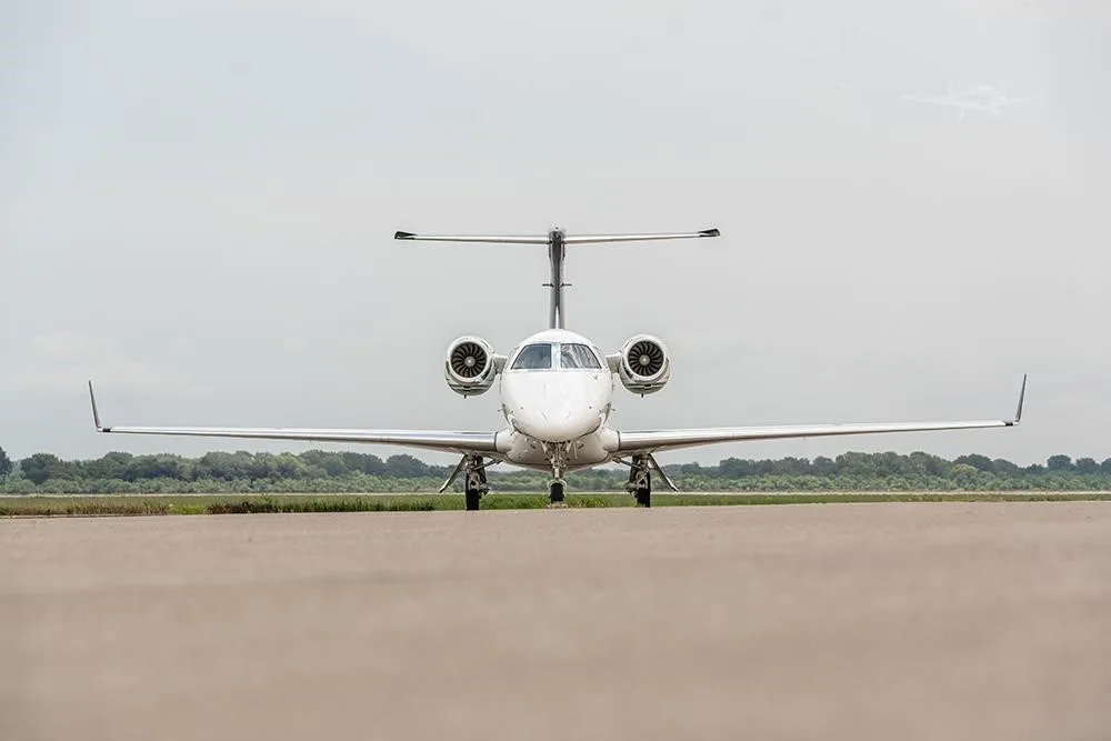 Exterior view of a 2018 EMBRAER PHENOM 300E, N156PG.
