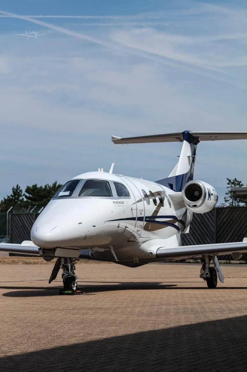 Exterior view of a 2016 EMBRAER PHENOM 100E, M-TOMY.