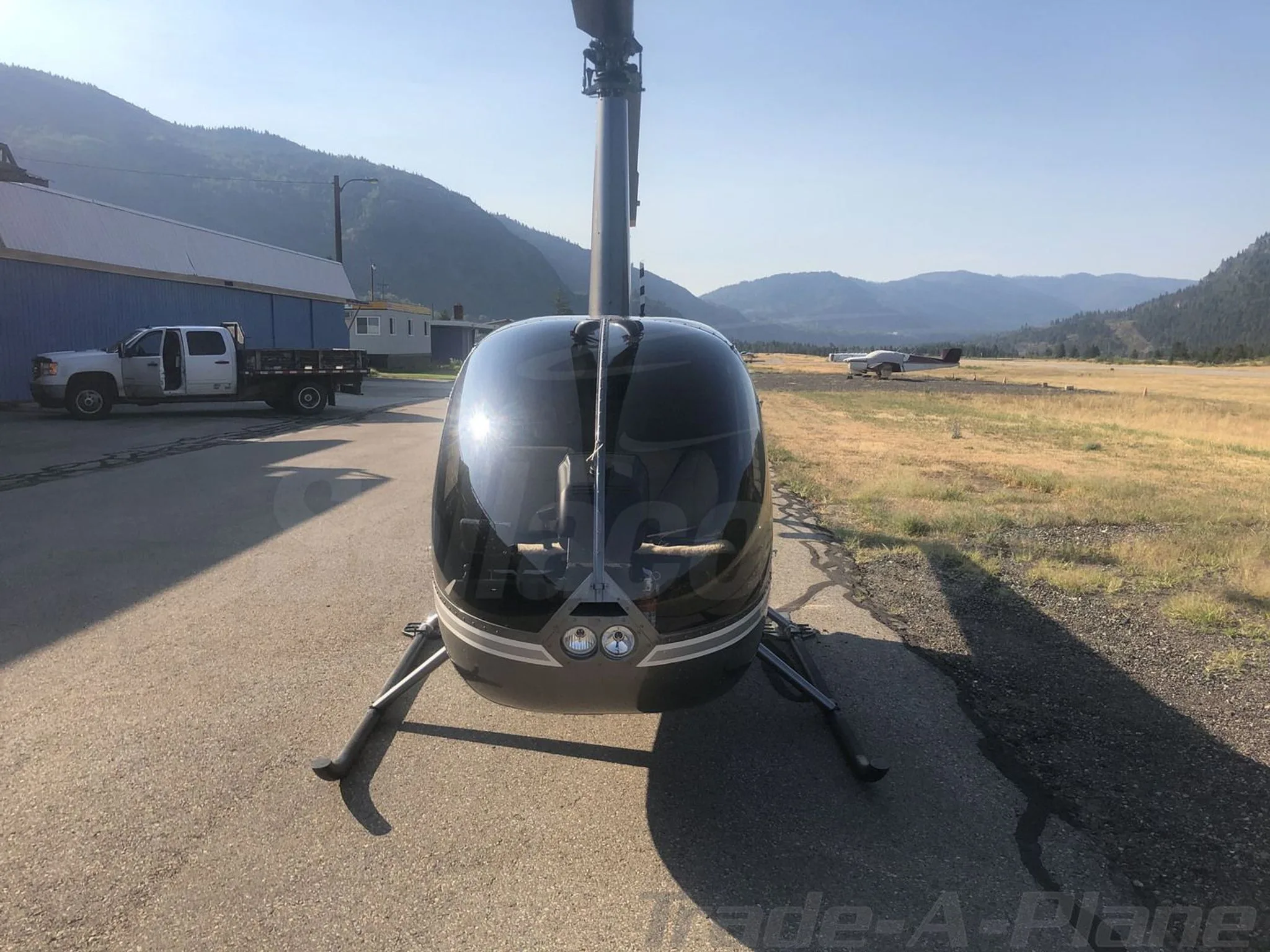 Exterior view of a 2017 ROBINSON R44, C-GFEE.
