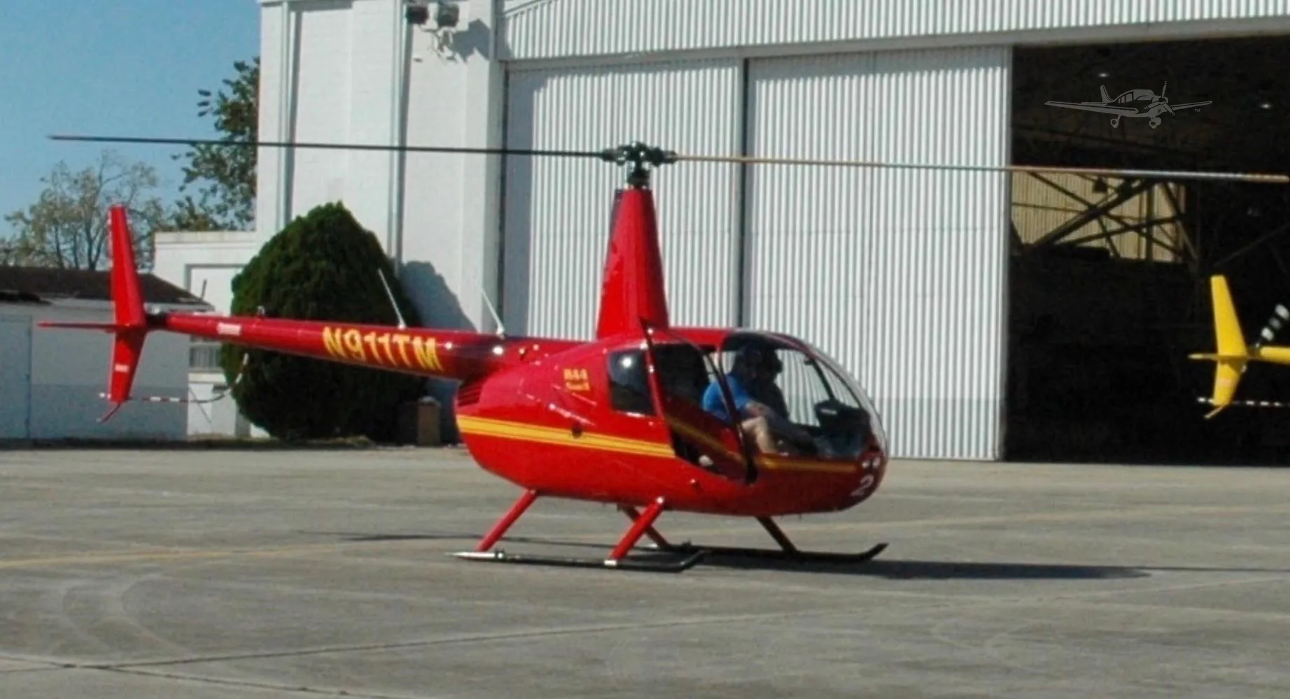 Exterior view of a 2003 ROBINSON R44 RAVEN II, N911TM.