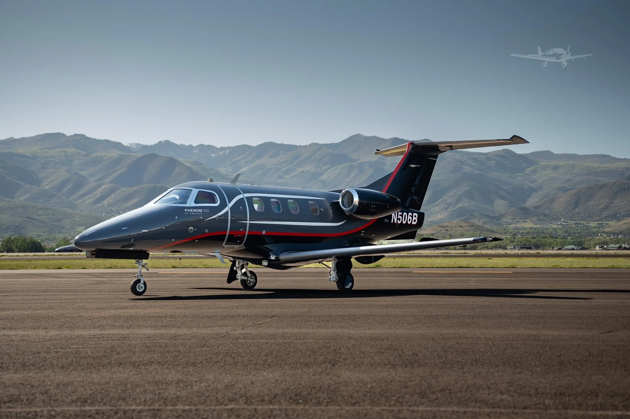 Exterior view of a 2013 EMBRAER PHENOM 100, N506B.