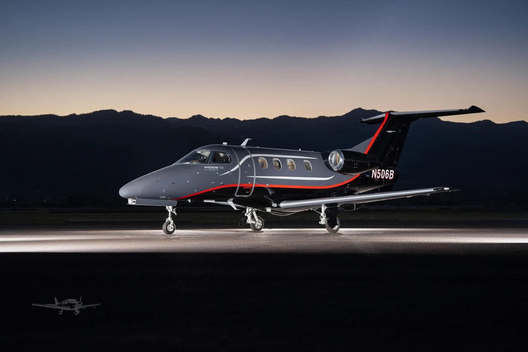 Exterior view of a 2013 EMBRAER PHENOM 100, N506B.