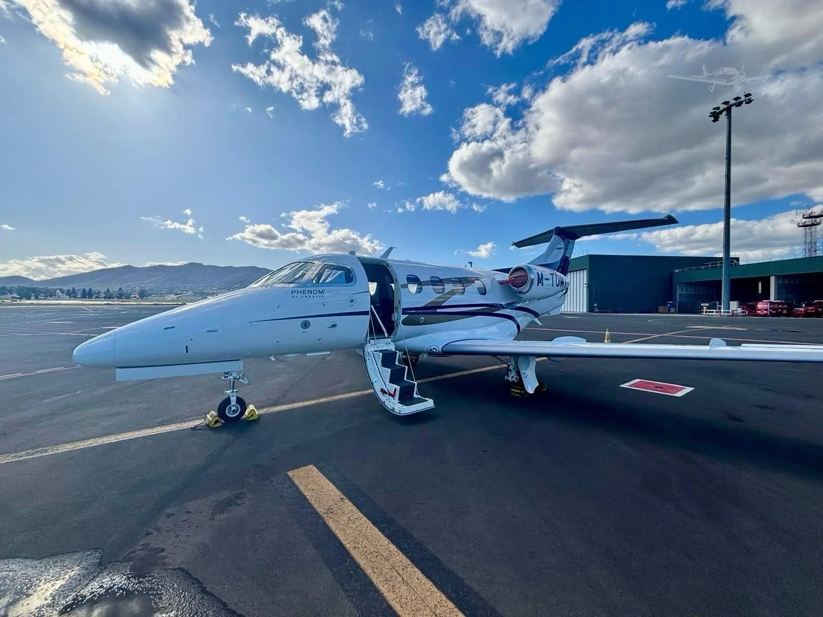 Exterior view of a 2016 EMBRAER PHENOM 100E, M-TOMY.