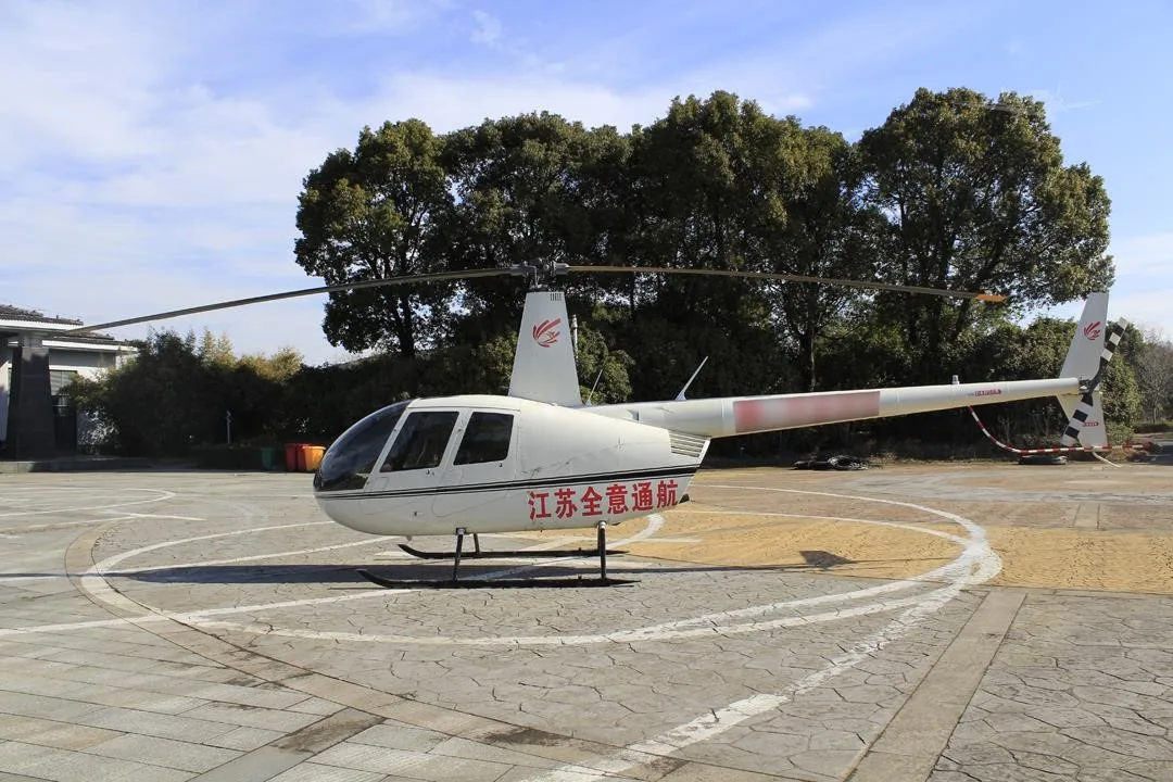 Exterior view of a 2014 ROBINSON R44 RAVEN II.