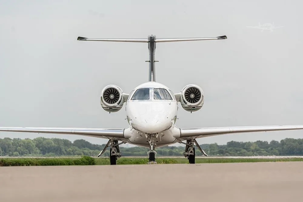 Exterior view of a 2018 EMBRAER PHENOM 300E, N156PG.