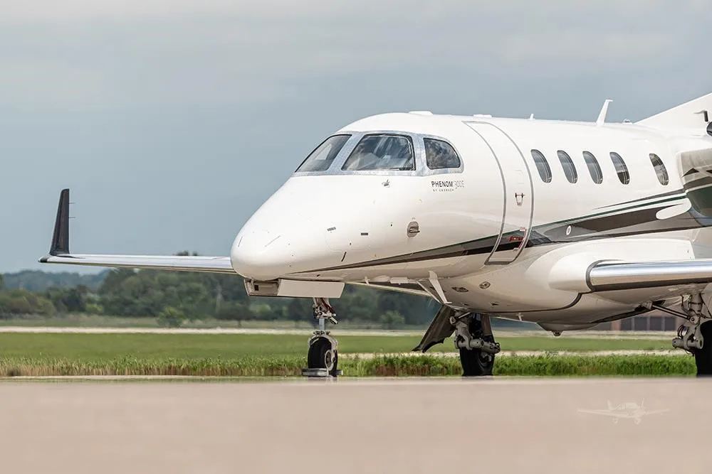 Exterior view of a 2018 EMBRAER PHENOM 300E, N156PG.