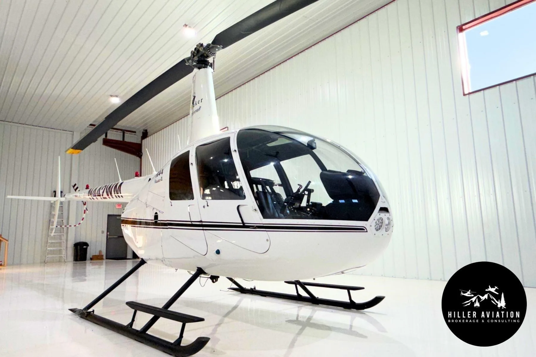Exterior view of a 2006 ROBINSON R44 RAVEN II, N442WM.