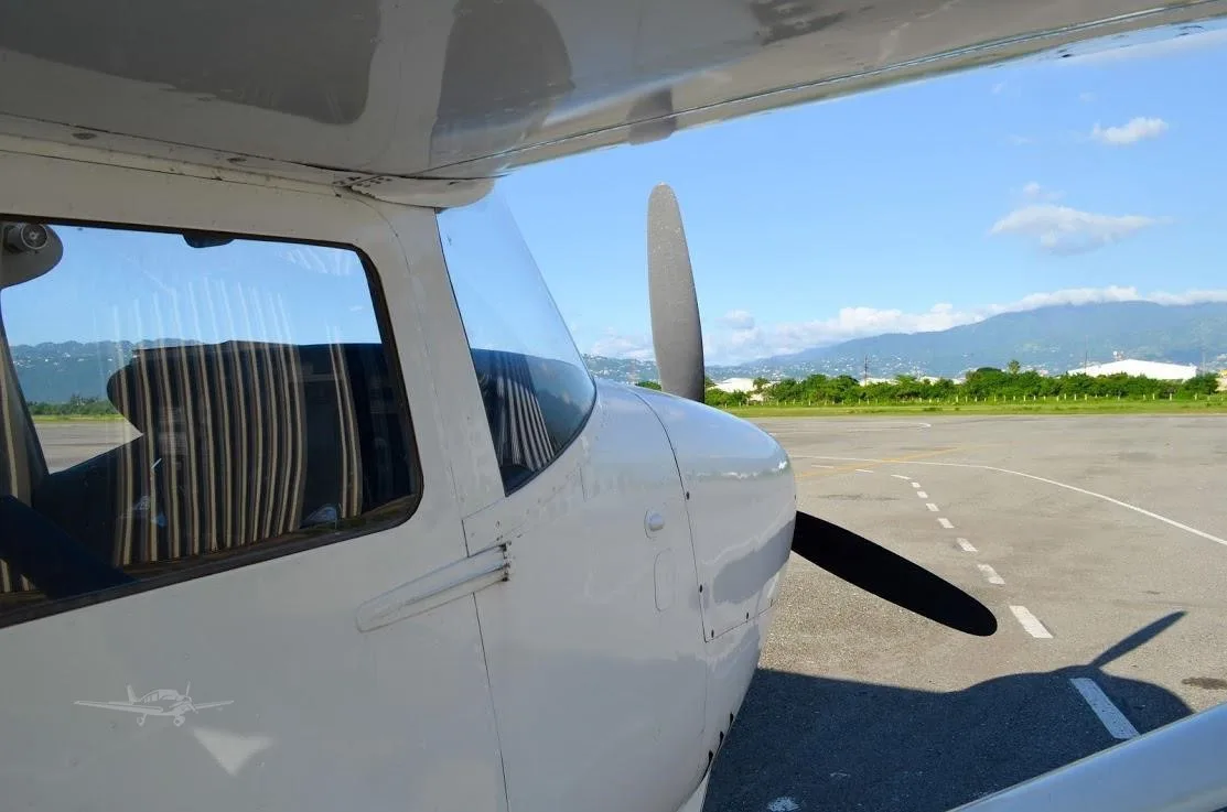 Exterior view of a 1967 CESSNA P206 SUPER SKYLANE, 6Y-JNE.