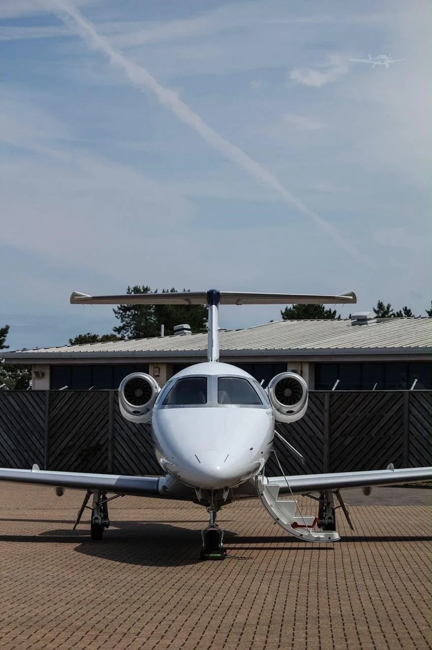 Exterior view of a 2016 EMBRAER PHENOM 100E, M-TOMY.