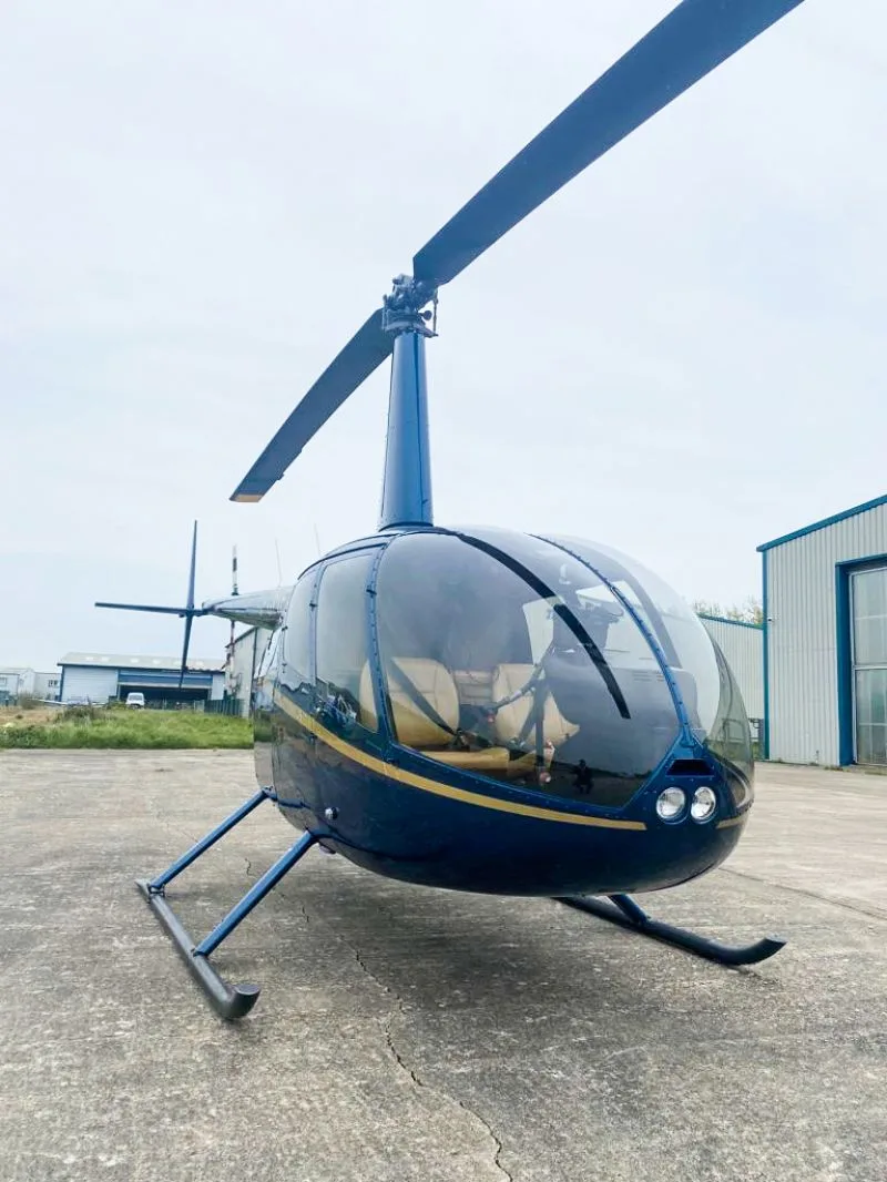 Exterior view of a 2011 Robinson R66, G-CMEA.