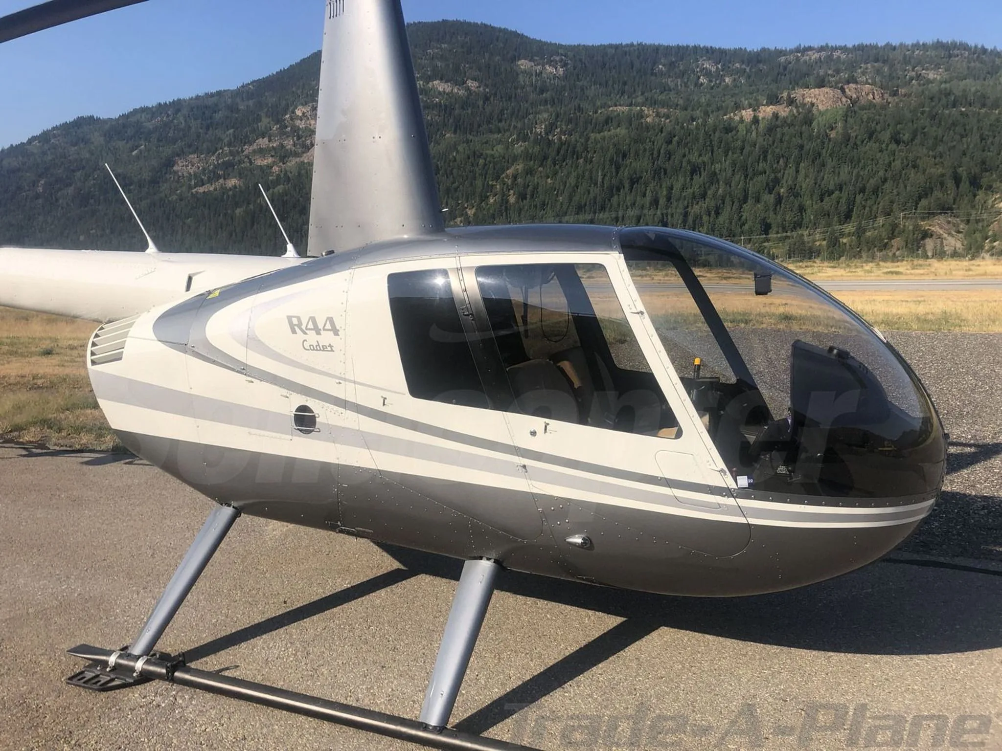 Exterior view of a 2017 ROBINSON R44, C-GFEE.