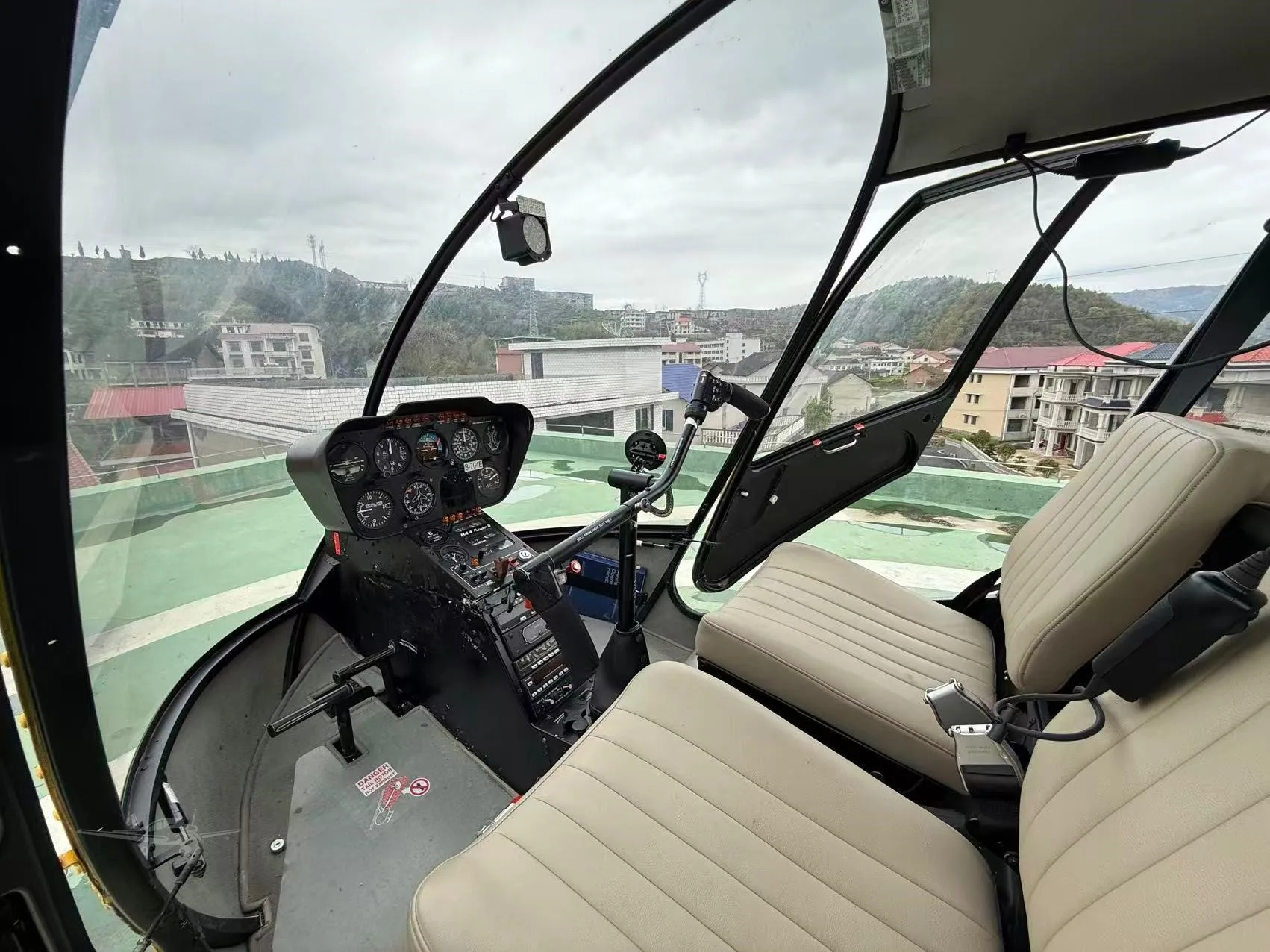 Cockpit and instrument panel of a 2003 ROBINSON R44 RAVEN II.