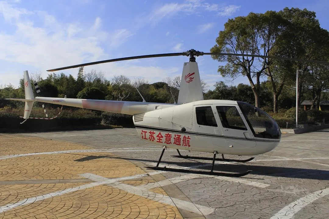 Exterior view of a 2014 ROBINSON R44 RAVEN II.