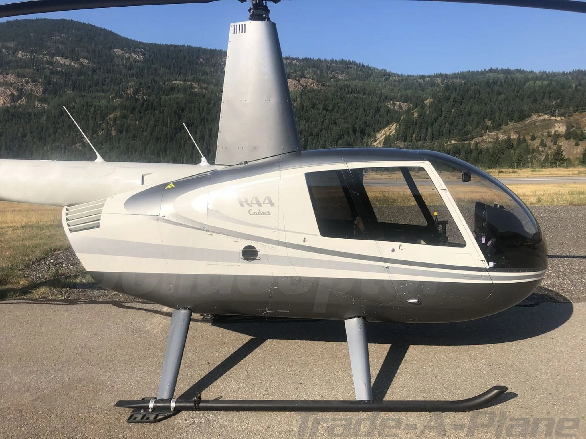 Exterior view of a 2017 ROBINSON R44, C-GFEE.