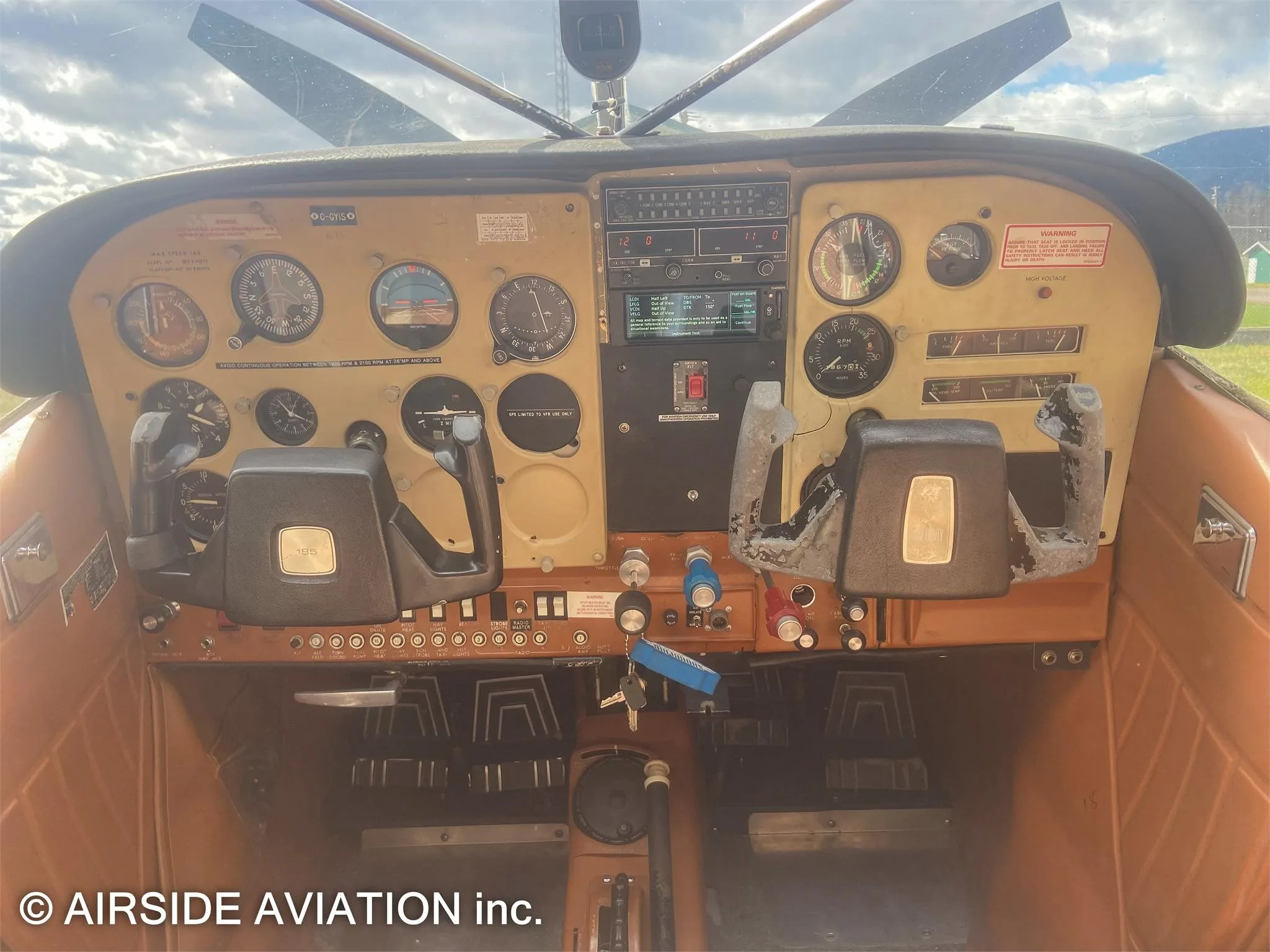 Cockpit and instrument panel of a 1976 CESSNA A185F FLOATPLANE.