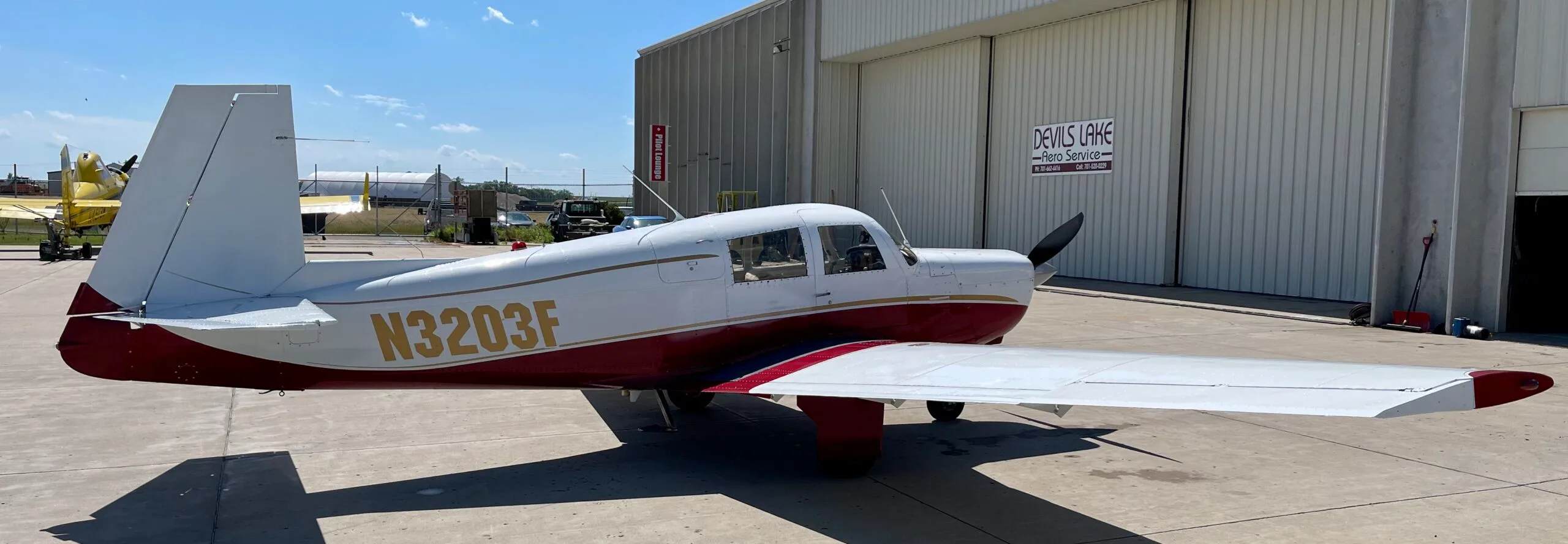 Exterior view of a 1967 Mooney M20C, N3203F.