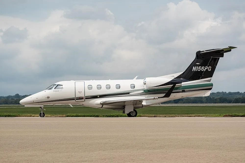 Exterior view of a 2018 EMBRAER PHENOM 300E, N156PG.