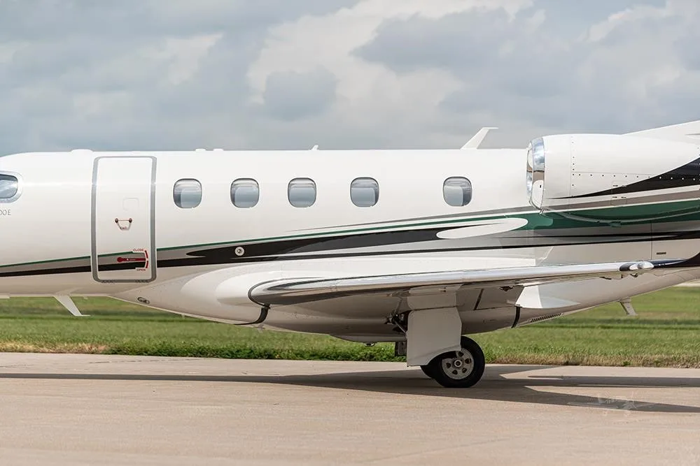 Exterior view of a 2018 EMBRAER PHENOM 300E, N156PG.