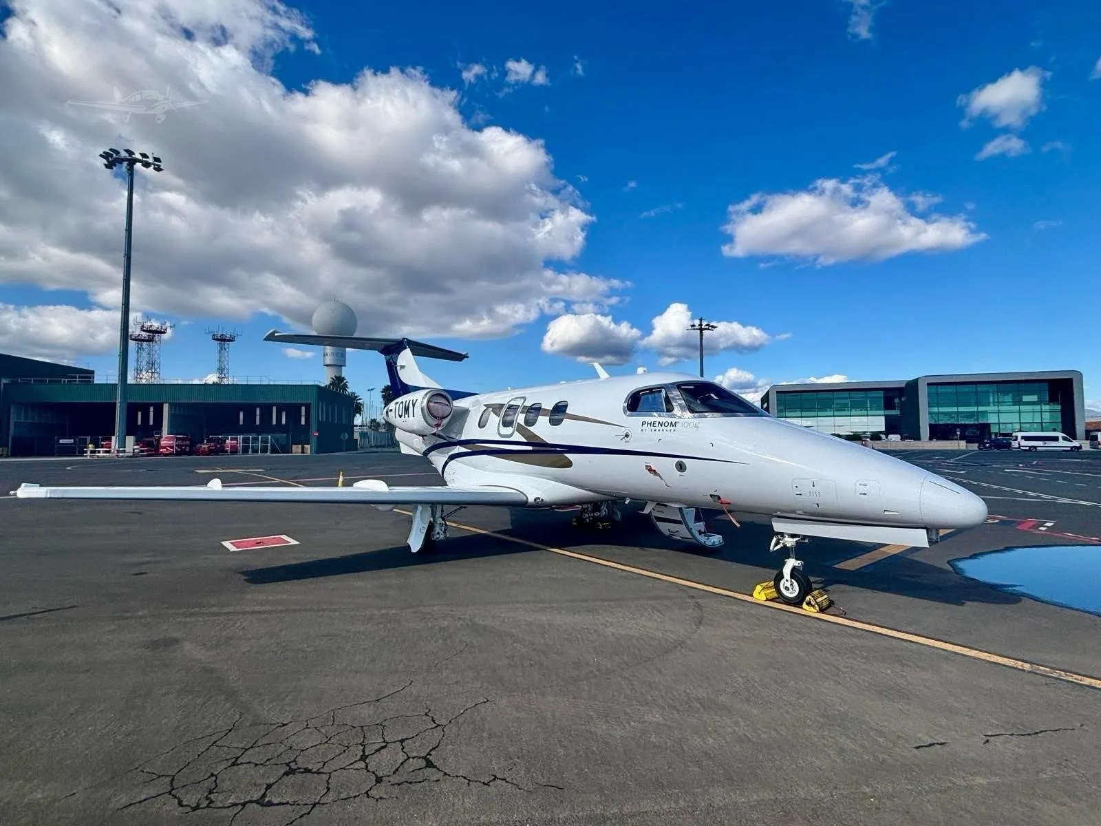 Exterior view of a 2016 EMBRAER PHENOM 100E, M-TOMY.