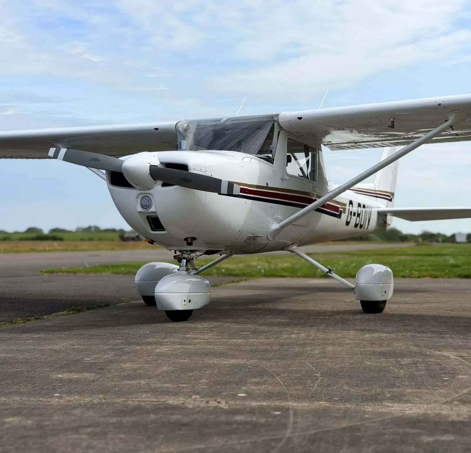Exterior view of a 1976 Cessna 150M, G-BOIV.