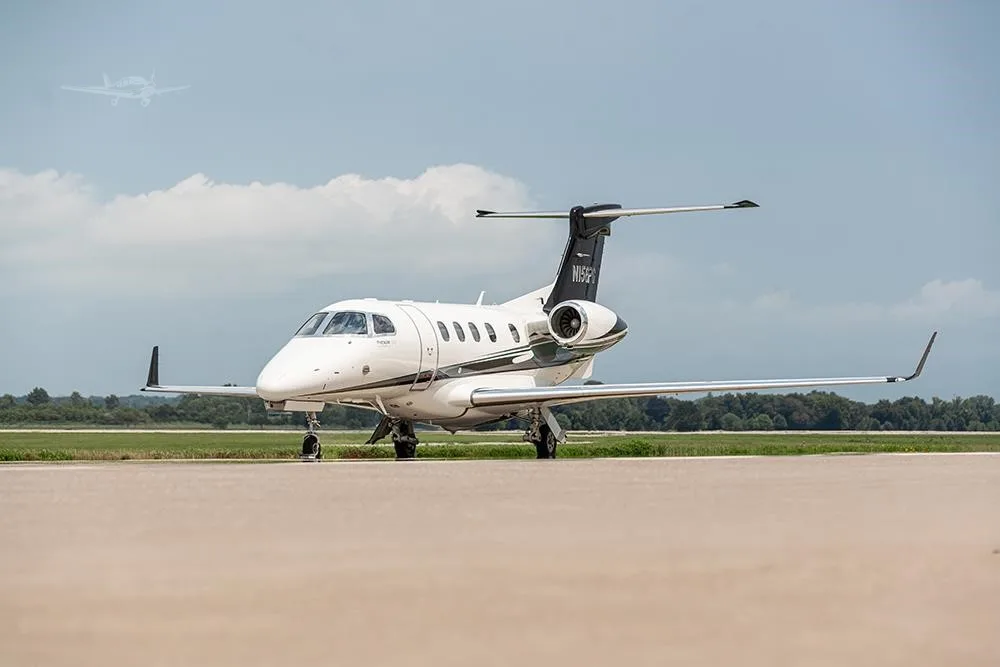 Exterior view of a 2018 EMBRAER PHENOM 300E, N156PG.