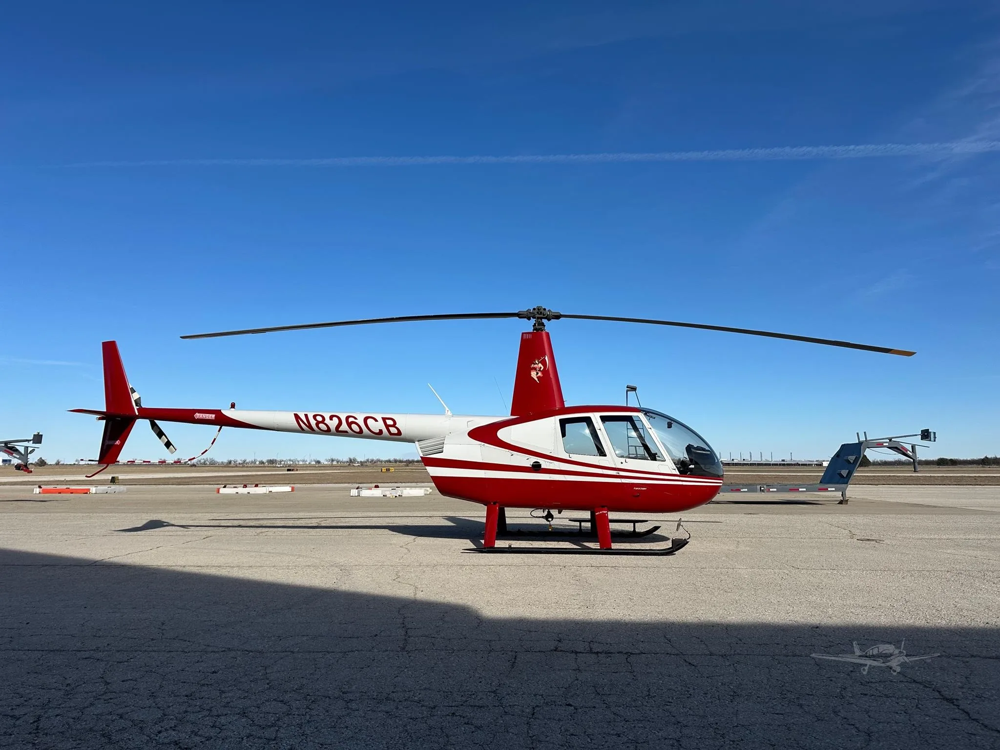 Exterior view of a 2006 ROBINSON R44 RAVEN II, N826CB.
