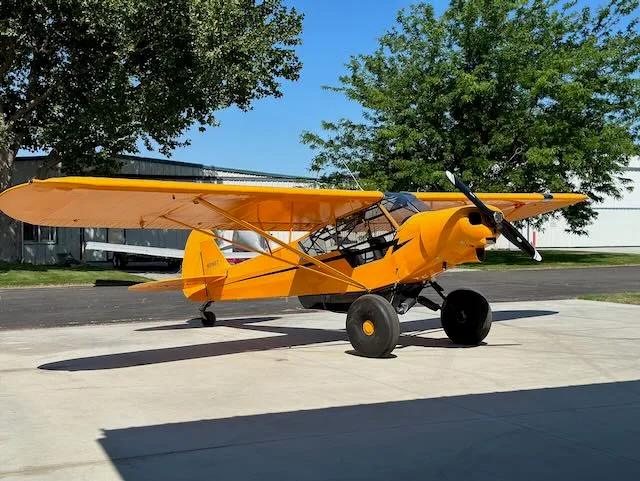 Exterior view of a 1979 Piper PA-18-150, N9166T.